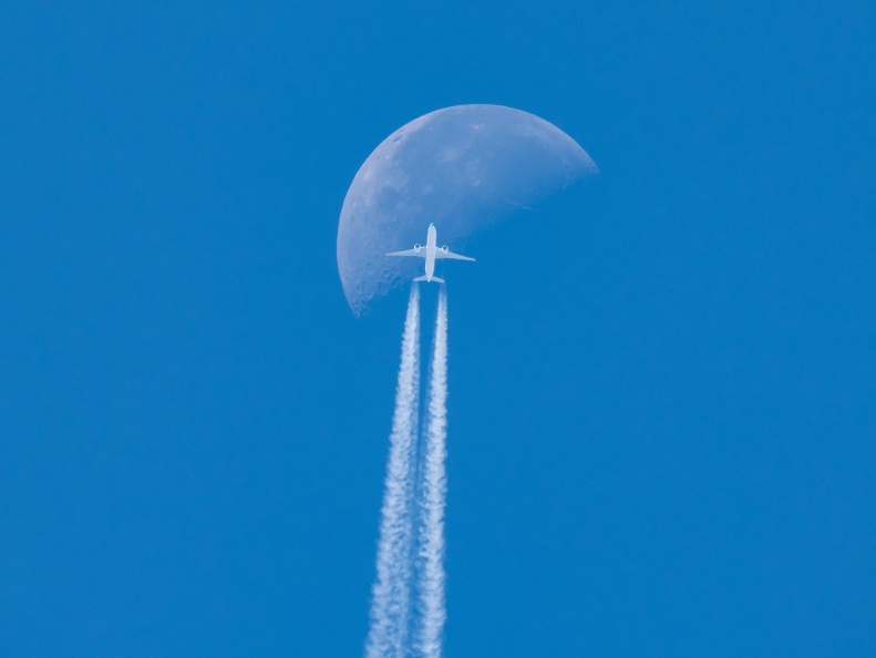 A KLM Boeing 777 with a contrail flying past the moon at cruising altitude over Wiltshire. 20240728-PLG9-P1000598.jpg